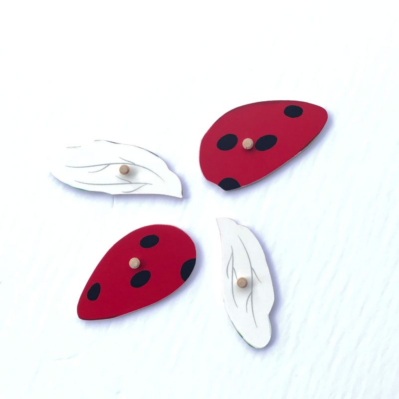 Wooden red ladybug puzzle parts.